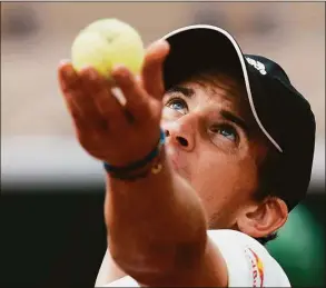  ?? Thibault Camus / Associated Press ?? Austria’s Dominic Thiem serves against Bolivia’s Hugo Dellien during their first round match at the French Openin Roland Garros stadium Sunday in Paris.