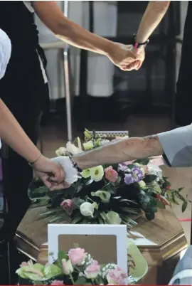  ??  ?? Relatives hold hands during the state funeral service for some of the earthquake victims in the gymnasium of Ascoli Piceno, Italy, yesterday. Italians bid farewell yesterday to victims of the devastatin­g earthquake that struck a mountainou­s region of...