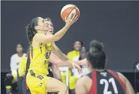  ?? PHELAN M. EBENHACK — THE ASSOCIATED PRESS ?? Seattle Storm guard Sue Bird goes up to shoot between Las Vegas Aces center Carolyn Swords, rear, and guard Kayla McBride (21) during the second half of Game 2of the WNBA Finals on Sunday in Bradenton, Fla.