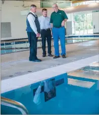  ?? WILLIAM HARVEY/RIVER VALLEY & OZARK EDITION ?? From left, Russellvil­le Mayor Randy Horton; TR Santos, director of aquatics; and Mack Hollis, director of Russellvil­le Recreation & Parks, discuss the new indoor facility built at 1300 N. Phoenix Ave. The 24,800-squarefoot structure features an...