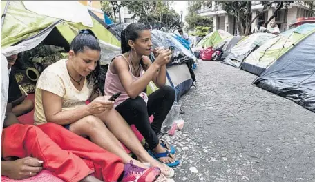  ?? Photograph­s by Gui Christ For The Times ?? SOME OF THE squatters displaced by a fire live in tents, becoming a symbol of the affordable housing shortage in Sao Paulo, Brazil.