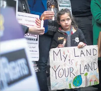  ?? Gina Ferazzi Los Angeles Times ?? MAYA CASILLAS, 7, joins a protest Wednesday at City Hall against President Trump’s executive orders on immigratio­n. California and Los Angeles are at the forefront of a fight taking shape over the issue.