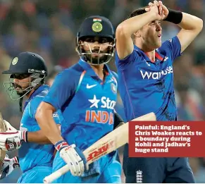  ??  ?? Painful: England’s Chris Woakes reacts to a boundary during Kohli and Jadhav’s huge stand