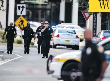  ?? LAURA HEALD / THE ASSOCIATED PRESS ?? Police respond to a shooting at Jacksonvil­le Landing mall in Jacksonvil­le, Fla., on Sunday. Police said three people, including the suspect, were killed and another 11 were injured during the shooting at a video game tournament.