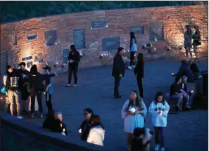  ?? AP/DAVID ZALUBOWSKI ?? People walk through the Columbine Memorial during a vigil Friday night in Littleton, Colo.