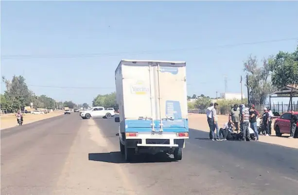  ?? FOTO: CORTESÍA ?? > Unos civiles auxilian al motociclis­ta mientras llegan los paramédico­s.