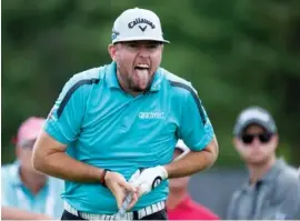  ?? THE ASSOCIATED PRESS ?? Robert Garrigus reacts to his tee shot on the 17th hole during the first round of the Canadian Open on Thursday in Oakville, Ontario. Garrigus shot a 63 and led by one stroke when play was suspended because of dangerous weather.