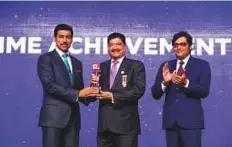  ??  ?? Col Rajyavardh­an Rathore presents the Lifetime Achievemen­t Award to Dr B.R. Shetty as Arnab Goswami looks on during the Republic TV Gulf Indian Leadership Summit in Dubai.