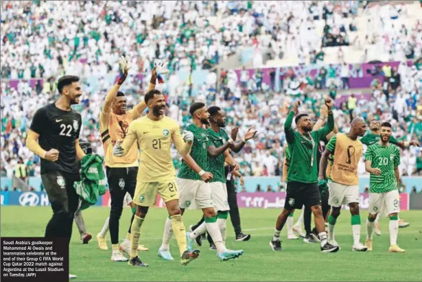  ?? (AFP) ?? Saudi Arabia’s goalkeeper Mohammed Al Owais and teammates celebrate at the end of their Group C FIFA World Cup Qatar 2022 match against Argentina at the Lusail Stadium on Tuesday.