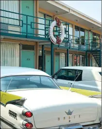  ?? National Civil Rights Museum ?? Old cars sit parked beneath the motel balcony on which Martin Luther King Jr. was standing when he was assassinat­ed on April 4, 1968. The National Civil Rights Museum surrounds the old motel.