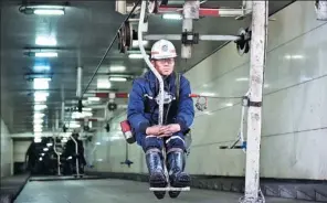  ?? XINHUA ?? A miner takes an overhead man-riding device to come out of a mine of Shanxi Jincheng Anthracite Coal Mining Group in Jincheng, Shanxi province.