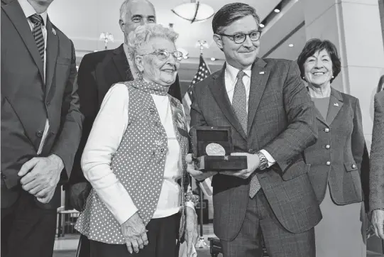  ?? KENNY HOLSTON NYT ?? House Speaker Mike Johnson, R-La., presents a Congressio­nal Gold Medal to Mae Krier during a ceremony at the Capitol in Washington on April 10. Congress passed legislatio­n authorizin­g the medal for Rosie the Riveter in 2020, after years of urging by Phyllis Gould and Krier, who accepted the award on behalf of all Rosies.