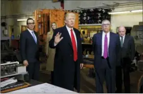  ?? EVAN VUCCI — THE ASSOCIATED PRESS ?? President Donald Trump takes tour of H&K Equipment Company with owners Peter Cicero and George Koch, right, during a visit to promote his tax and economic plan Thursday in Coraopolis, Pa. Treasury Secretary Steven Mnuchin and Ivanka Trump listen in the...