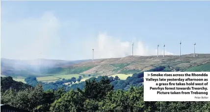  ?? Peter Bolter ?? &gt; Smoke rises across the Rhondda Valleys late yesterday afternoon as a grass fire takes hold west of Penrhys forest towards Treorchy. Picture taken from Trebanog