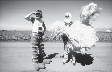  ?? Debra Spinney
Tribeca Film ?? CAROLL SPINNEY, left, prepares to don Big Bird’s yellow-feathered costume with help of Kermit Love.