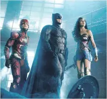  ?? WARNER BROS. ?? Ezra Miller, left, as The Flash, Ben Affleck, as Batman, and Gal Gadot, as Wonder Woman, star in Justice League.