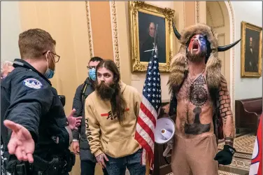  ?? (File Photo/AP/Manuel Balce Ceneta) ?? Supporters of President Donald Trump, including Jacob Chansley (right), are confronted Jan. 6, 2021, by U.S. Capitol Police officers outside the Senate Chamber inside the Capitol in Washington. Stories circulatin­g online incorrectl­y claim footage from the Jan. 6, 2021, attack on the U.S. Capitol shows that Chansley was “led through the Capitol by police the entire time he was in the building.”