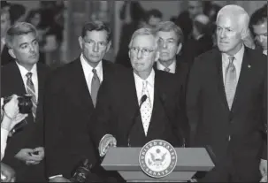  ?? The Associated Press ?? BACKUP PLAN: Senate Majority Leader Mitch McConnell, of Ky., center, joined by, from left, Sen. Cory Gardner, R-Colo., Sen. John Barrasso, R-Wyo., Sen. Roy Blunt, R-Mo., and Senate Majority Whip John Cornyn, of Texas, speaks during a news conference...