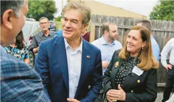  ?? TARUTIS/WILKES-BARRE CITIZENS BILL ?? Mehmet Oz greets a supporter at a barbecue Thursday in Luzerne County. With him is state Sen. Lisa Baker, R-Luzerne.