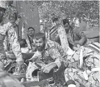  ?? BEHRAD GHASEMI/ISNA/AP ?? Iranian armed forces members and civilians take shelter during a shooting at a military parade in the city of Ahvaz.