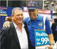  ??  ?? Eric Bauman, left, who is running to head the California Democratic Party, talks with Horace Snowden, of the Placer County Democratic Party before the start of the California Democratic Party convention on Friday in Sacramento.