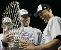  ?? DAVID J. PHILLIP — ASSOCIATED PRESS FILE ?? In a November 2009 photo, Rivera, right, and teammate Derek Jeter admire the world championsh­ip trophy after the Yankees defeated the Phillies in Game 6 of the World Series.