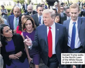  ??  ?? Donald Trump walks to the North Lawn of the White House to give an interview