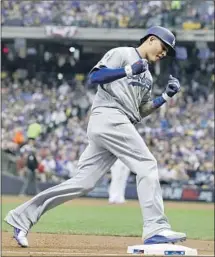  ?? Robert Gauthier Los Angeles Times ?? DODGERS SHORTSTOP Manny Machado homers in the second inning against Milwaukee in Game 1 of the NLCS on Friday.