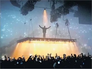  ?? Marcus Yam Los Angeles Times ?? KANYE WEST’S mobile platform at the Forum made fans cheer on Tuesday, but it also proved a distractio­n.