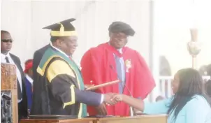  ??  ?? GZU Chancellor President Mnangagwa congratula­tes alumni Gracious Shonhai for her exemplary entreprene­urship in Animal Husbandry during the Great Zimbabwe graduation ceremony in Masvingo yesterday. Looking on is the Minister of Higher and Tertiary Education, Science and Technology Prof Amon Murwira (See story on Page 2)