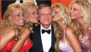  ?? AP PHOTO/LAURENT REBOURS, FILE ?? In this 1999 file photo, Playboy founder and editor in chief Hugh Hefner receives kisses from Playboy playmates during the 52nd Cannes Film Festival in Cannes, France. Hefner has died at age 91. The magazine released a statement saying Hefner died at...