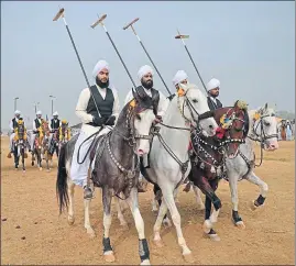  ?? AAMIR QURESHI/AFP ?? Sikhs, who now form a tiny minority in the Punjab province in Pakistan, among riders holding lances at a tentpeggin­g competitio­n during an annual festival at Kot Fateh Khan village in Attock district of Pakistan’s Punjab province; (right) a rider in...