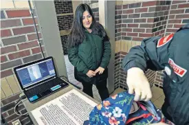  ?? [AP PHOTO] ?? Alondra Alvarez, a student at Western Internatio­nal High School in Detroit, goes through a metal detector and has her backpack checked Thursday as she enters the school. Experts say metal detectors and other security measures put in place decades ago...