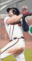  ?? Ap-brynn Anderson ?? Adam Duvall hit three of the Braves’ seven home runs and drove in nine as Atlanta set the new franchise and National League records in their win over the Marlins.