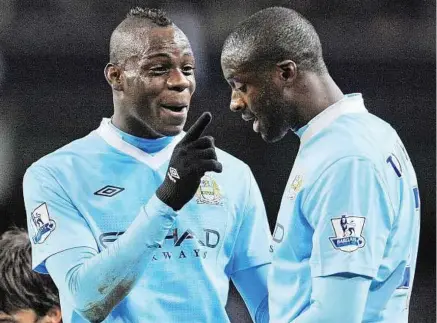  ??  ?? What bust-up?: Manchester City’s Yaya Toure (right) dismisses reports of dressing-room row with Mario Balotelli. — AFP