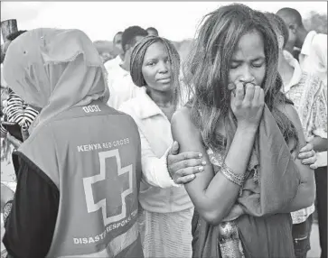  ?? Carl De Souza AFP/Getty Images ?? EVACUATED STUDENTS gather in Garissa, Kenya, before being taken home. At least 148 died in the siege by the militant group Shabab. Some accused Kenyan authoritie­s of disregardi­ng warnings of an attack.