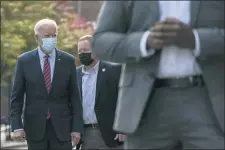  ?? CAROLYN KASTER - THE ASSOCIATED PRESS ?? Democratic presidenti­al candidate former Vice President Joe Biden walks to his motorcade vehicle after talking with Wilmington, Del., police officers as he departs The Queen theatre in Wilmington, Del., Monday, Oct. 19.