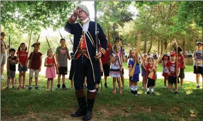  ?? AP/The Free Lance-Star/MIKE MORONES ?? Hector Diaz, portraying Bernardo de Galvez, the Spanish governor of Louisiana, drills children in Revolution­ary War-era tactics at an event Wednesday in Fredericks­burg, Va.