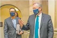  ?? AP PHOTO/MANUEL BALCE CENETA ?? White House chief of staff Mark Meadows, right, and Treasury Secretary Steven Mnuchin arrive at the office of House Speaker Nancy Pelosi at the Capitol to resume talks on a COVID-19 relief bill Saturday in Washington.