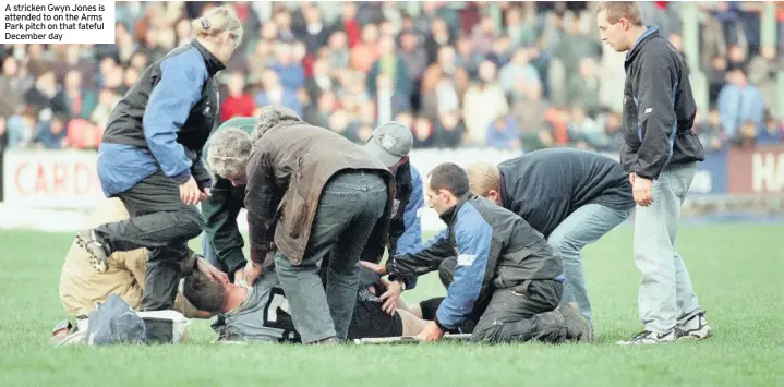  ??  ?? A stricken Gwyn Jones is attended to on the Arms Park pitch on that fateful December day