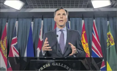  ?? CP PHOTO ?? Minister of Finance Bill Morneau speaks with the media in Ottawa. Health groups have joined forces with the Conservati­ve opposition to accuse the Liberal government of trying to raise tax revenue on the backs of vulnerable diabetics.