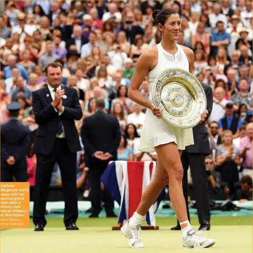  ?? David Ramos / Press Associatio­n ?? Garbine Muguruza walks away with her second grand slam after a victory over Venus Williams at Wimbledon
