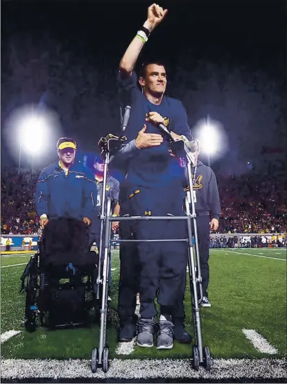  ?? PHOTOS COURTESY OF CAL ATHLETICS ?? Former Cal rugby player Robert Paylor of El Dorado Hills waves to the crowd while being honored at halftime of a Golden Bears football game.