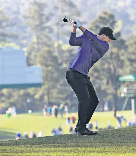  ??  ?? Taking aim: Rory McIlroy during a practice round at Augusta yesterday