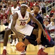  ?? Arkansas Democrat-Gazette/MELISSA SUE GERRITS ?? Arkansas forward Bobby Portis,
who had a team-high 15 points Saturday night in a 72-60 victory over South Alabama in North Little Rock, tries to keep the ball away from the Jaguars’ Aakim Saintil.
