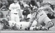  ?? Victor Decolongon Getty Images ?? CHRIS TAYLOR beats the tag of Willson Contreras to score the go-ahead run in the eighth inning.