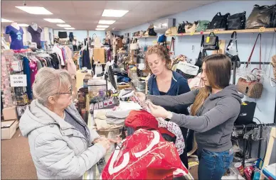  ?? PATRICK RAYCRAFT/HARTFORD COURANT ?? Store managers Tori Conlin, right, and Melissa Ladis, center, size up clothing for possible consignmen­t at Your Closet Or Mine Consignmen­t &amp; Boutique in Middletown. Barbara Czasak, left, of New Britain, brought in two full bags of clothes that had belonged to her daughter, who is now living and working in New York City.