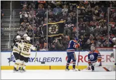  ?? JASON FRANSON — THE CANADIAN PRESS VIA AP ?? David Pastrnak, left, celebrates with Bruins teammates after a goal against the Oilers during the second period of Monday’s game in Edmonton, Alberta.