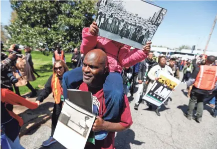  ??  ?? Marchers make their way through Memphis on Wednesday, April 4, during the I Am A Man march to commemorat­e the 50th anniversar­y of Martin Luther King Jr.’s assassinat­ion in Memphis, Tenn. MARK WEBER / THE COMMERCIAL APPEAL