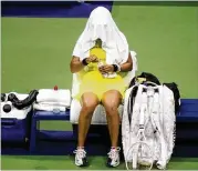  ?? FRANK FRANKLIN II/AP ?? Naomi Osaka sits between games against Leylah Fernandez in their third-round match at the U.S. Open, which she lost 5-7, 7-6 (2), 6-4 Friday.